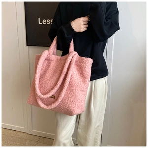 Detail of pink faux fur tote bag showing the soft plush texture and dual handle design