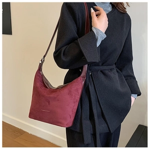 Detail of vintage burgundy hobo bag in soft suede and smooth leather textures