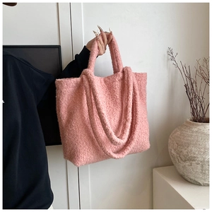 Close-up of pink fuzzy teddy fur tote bag with plush texture and large capacity
