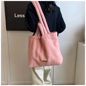 Detail of pink faux fur tote bag showing soft texture and spacious commuter design