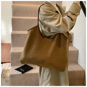 Detail of the large brown plush tote bag showing soft lamb wool texture and faux fur finish