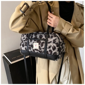 Detail of leopard print plush bowling bag with black leather trim and EUNBUFO brand patch