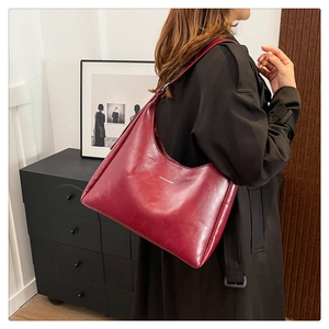 Macro view of the burgundy PU leather tote bag with a high-quality textured finish