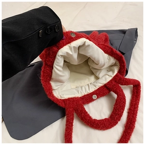 Detail view of the red plush tote bag interior with magnetic snap closure and soft lining