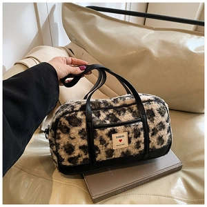 Fashionable leopard print faux fur handbag with black leather trim and double handles