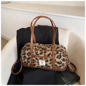Stylish leopard print plush boston bag with brown leather trim and top handles
