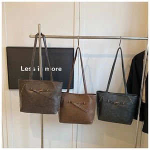 Three large oil wax leather tote bags in grey, brown and black for a minimalist look