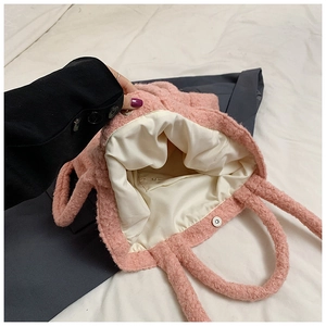 Detail view of pink plush tote bag showing the soft fabric lining and magnetic closure