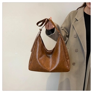 Detail of vintage brown PU tote bag with Fashion & Bags print and wide shoulder strap