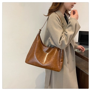 Model wearing a brown PU leather hobo shoulder bag with Fashion & Bags print