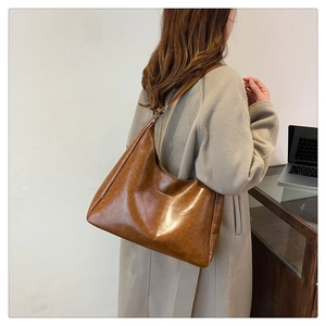 Detail of vintage brown PU leather hobo bag showing large capacity and smooth texture