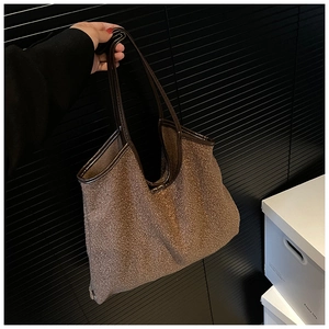 Brown faux fur tote bag with leather handles and spacious interior for autumn fashion