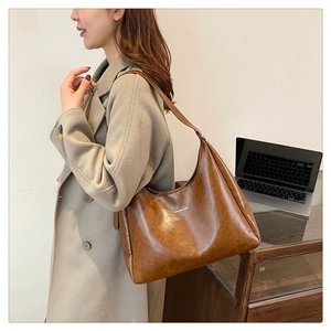 Close-up of brown vintage PU leather hobo bag with Fashion & Bags logo for daily commute