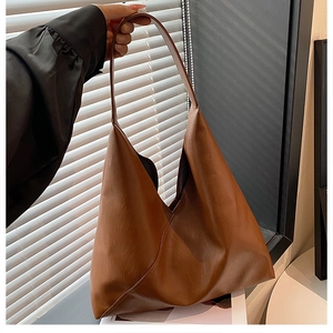 Brown large capacity leather tote bag with unique diagonal stitching and shoulder straps