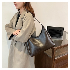 Macro shot of dark brown PU leather hobo bag with Fashion & Bags printed text details