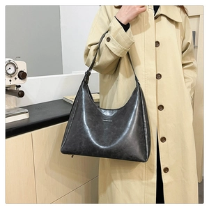 Detail showing the retro textured dark gray PU leather material and minimalist logo