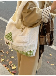 Détail du sac à main en peluche avec patch à carreaux verts, bouton et dentelle