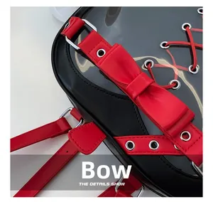 Detail shot of a black leather backpack with a red bowknot and transparent PVC window