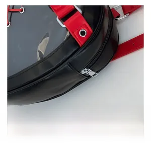 Detail of smooth metal zipper and transparent window on black and red backpack