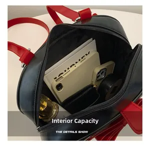Internal view of black and red crossbody bag showing spacious capacity with personal items