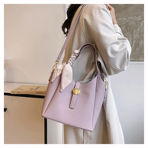 Detail of light purple lychee pattern bucket bag with silk scarf on the handle