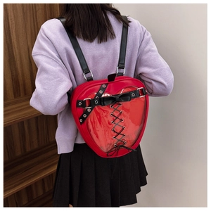 Detail view of the transparent PVC window and black decorative bow on the red heart backpack
