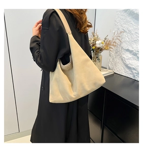 Dettaglio della borsa hobo beige minimalista che mostra la grande capacità e la texture morbida