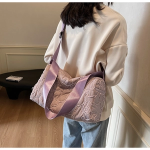 Close-up of lavender quilted fabric with 3D floral texture on a casual crossbody bag