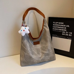 Gray canvas tote bag with brown leather straps and star pendant for summer style