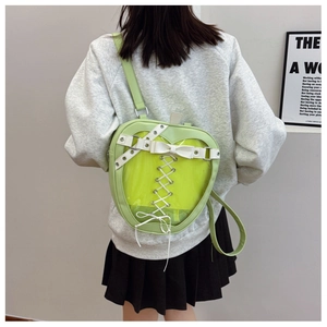 Detail showing back view of light green apple-shaped clear backpack with bow ribbons