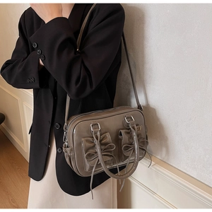 Brown vintage faux leather satchel bag with bow pockets and adjustable shoulder strap