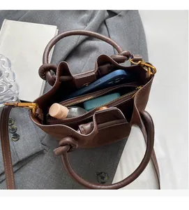 Interior view of brown suede bucket bag showing spacious capacity with personal items