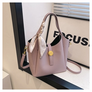 Lavender lychee leather bucket bag with top handle, decorative scarf and gold logo
