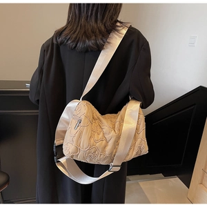 Detail of apricot quilted floral nylon crossbody bag with adjustable wide strap for women