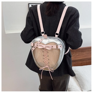 Close-up of heart-shaped silver and pink ita bag with transparent PVC panel and bow