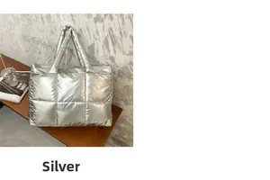 Detail of silver quilted padded tote bag featuring soft square stitching and metallic finish