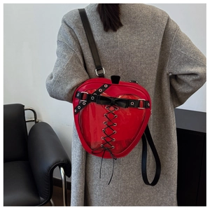 Fashionable red heart-shaped itabag with clear window on a grey tweed coat outfit