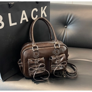 Vintage chocolate brown PU leather handbag with white stitching and bow-tied double pockets