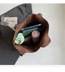 Top view of spacious dark brown tote bag interior with daily work essentials