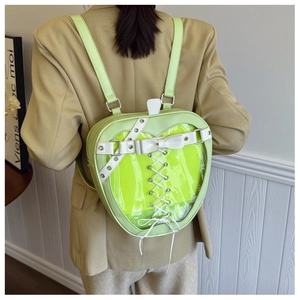 Detailed close-up of apple-shaped Itabag with heart transparent window and ribbon