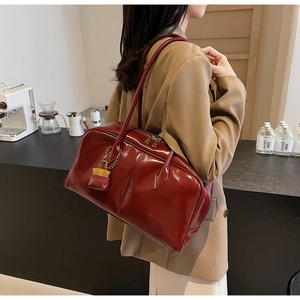 Deep red high-gloss PU leather shoulder bag with a matching mini pouch charm detail