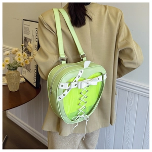 Detail of apple green heart-shaped ita bag with clear window and ribbon decor