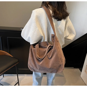 Detail of dark brown faux suede tote bag showing large capacity and soft texture