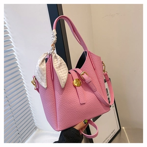 Pink lychee grain leather bucket bag with silk scarf handle and gold hardware detail