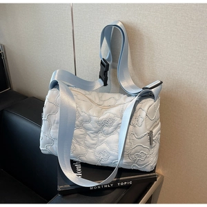 Chic light blue floral quilted nylon crossbody bag with wide strap and buckle detail