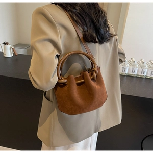 Deep brown faux suede bucket bag featuring elegant pleated design for autumn and winter outfits