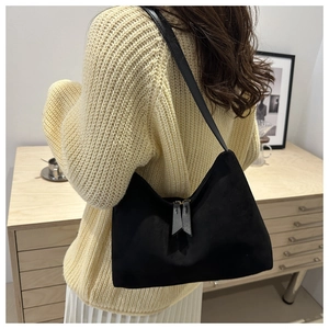 Detail view of black matte underarm bag with metal zipper and long leather pullers