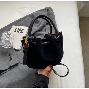 Retro black suede bucket bag with leather handles and gold hardware for autumn winter