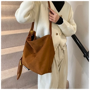 Close-up of brown frosted suede hobo bag with matching coin purse and leather strap