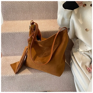 Close-up of brown frosted suede tote bag with matching inner pouch on steps